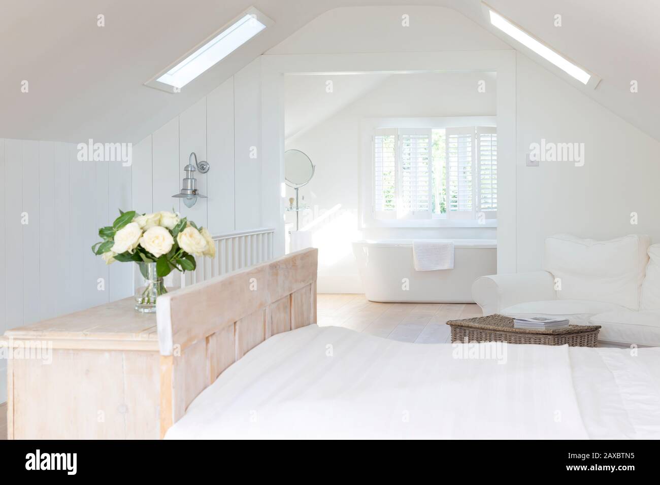 White a-frame home showcase bedroom with en suite bathroom Stock Photo