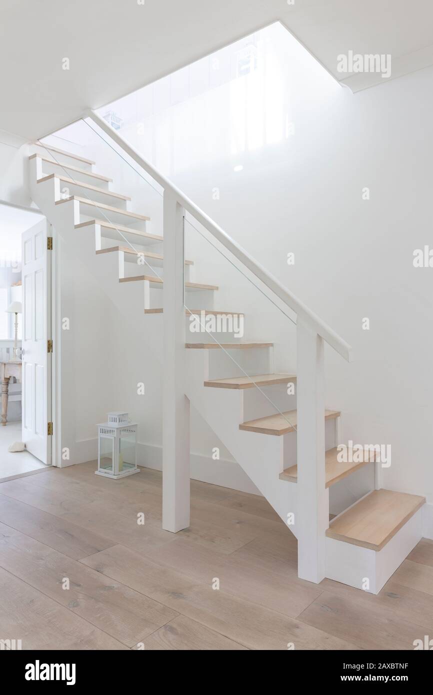 Simple white and wood stairs in home showcase foyer Stock Photo