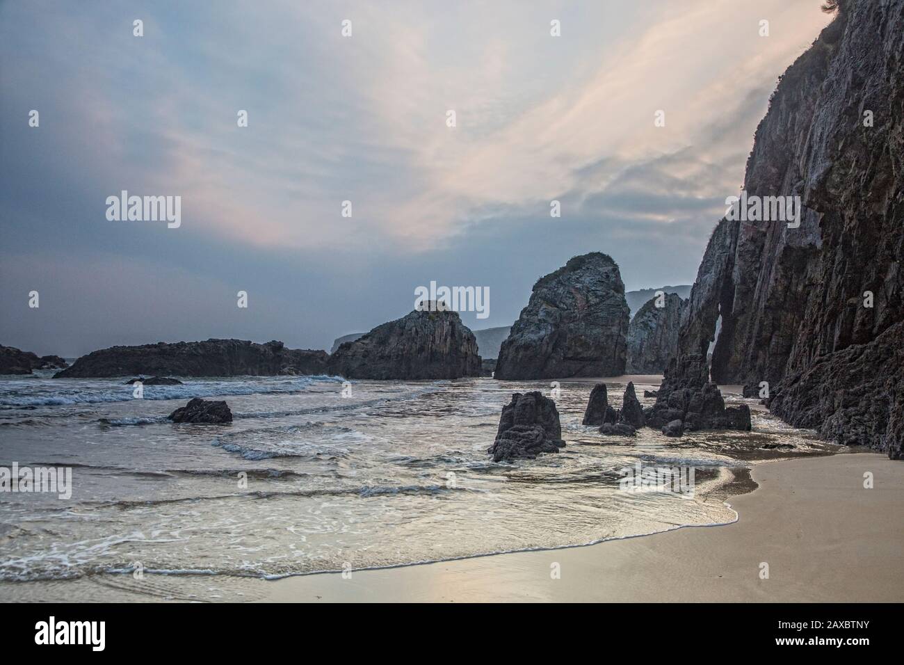 Rocks and cliff along La Franca Beach Asturias Spain Stock Photo