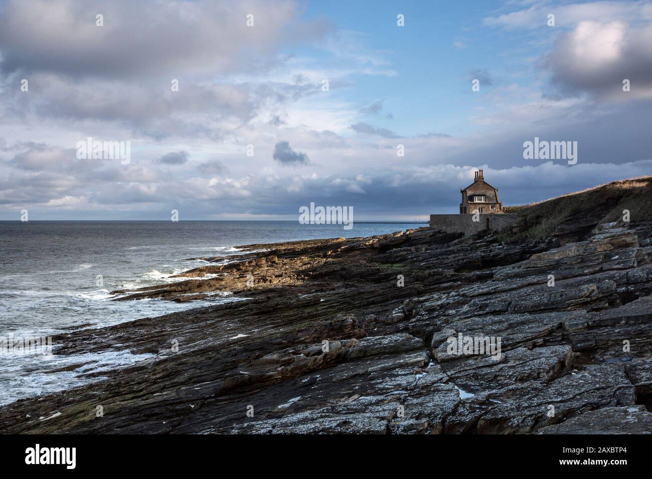 House overlooking rocky seascape Howick Northumberland UK Stock Photo