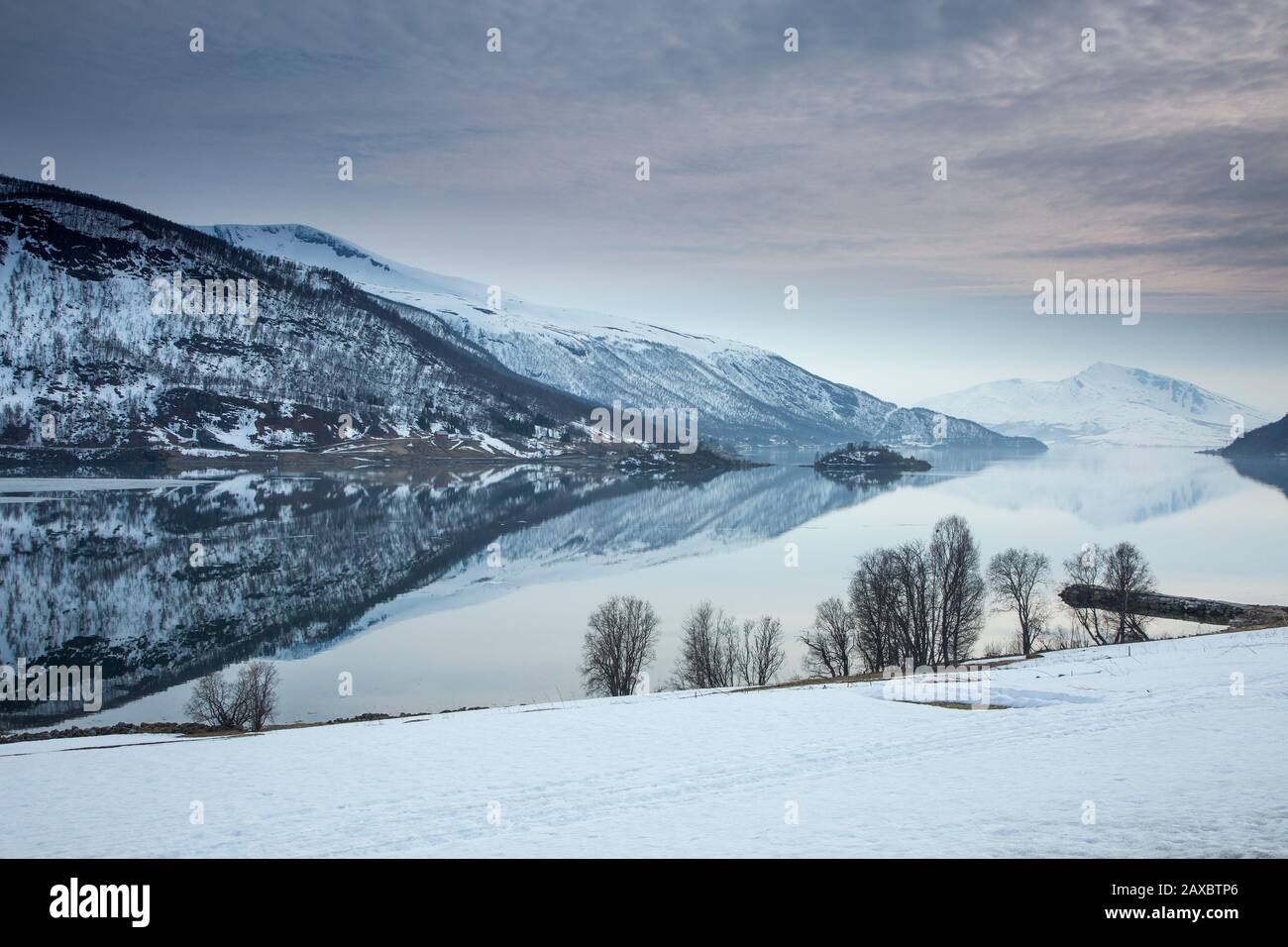Tranquil lake and snow covered mountains Norway Stock Photo