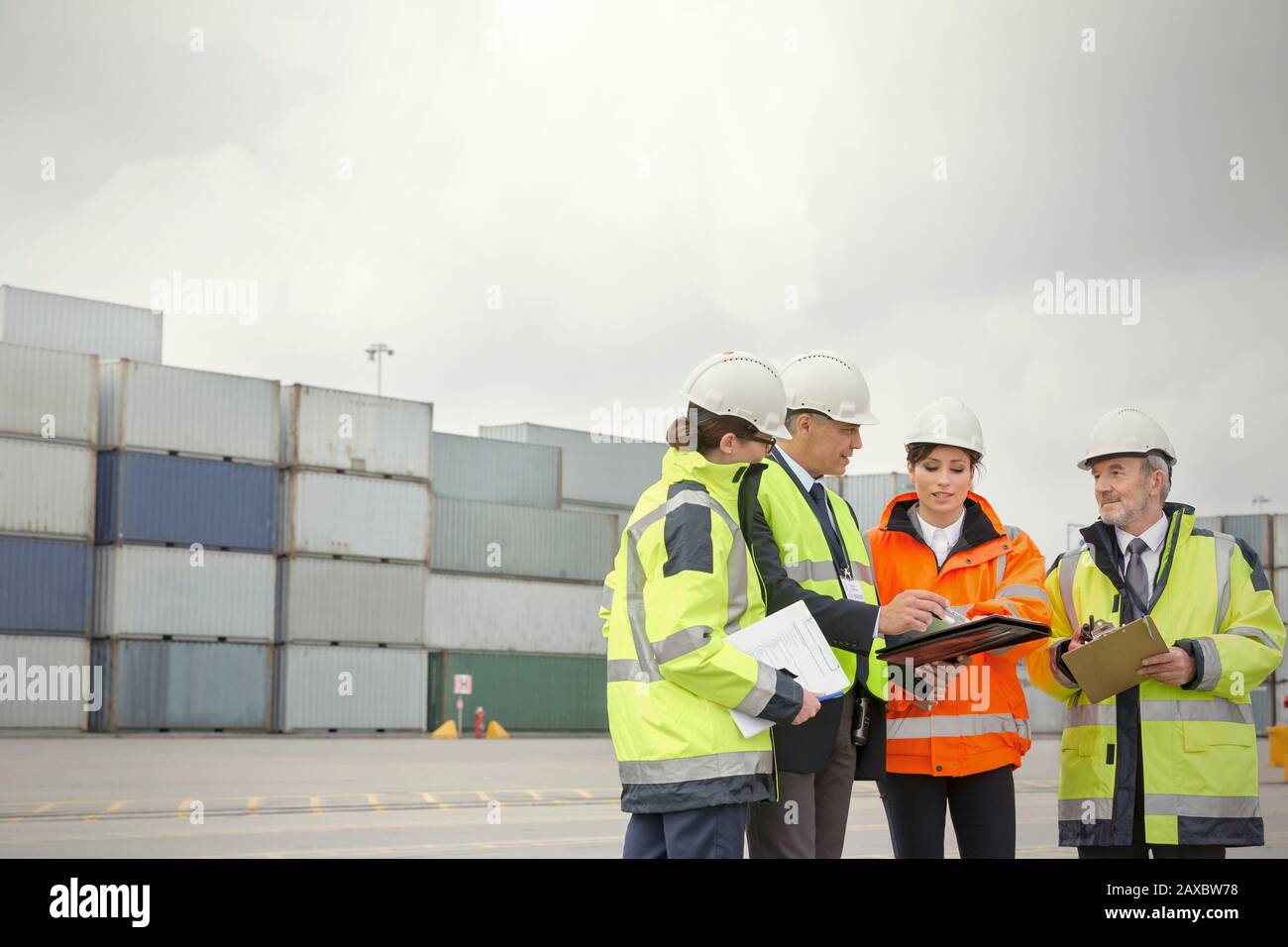 Dock workers and manager talking at shipyard Stock Photo