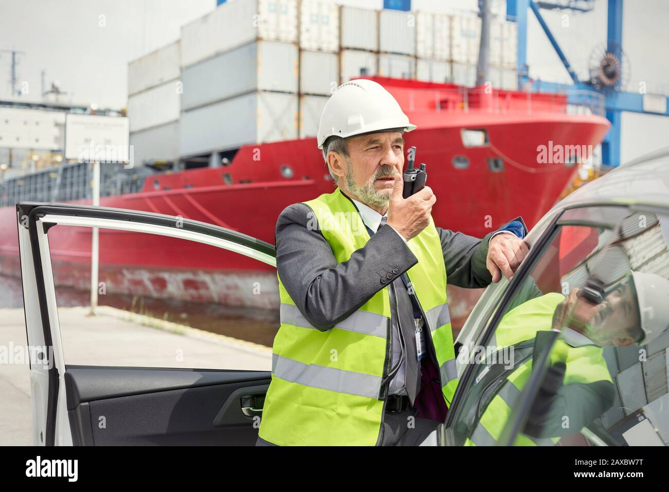 Dock manager using walking-talkie at shipyard Stock Photo