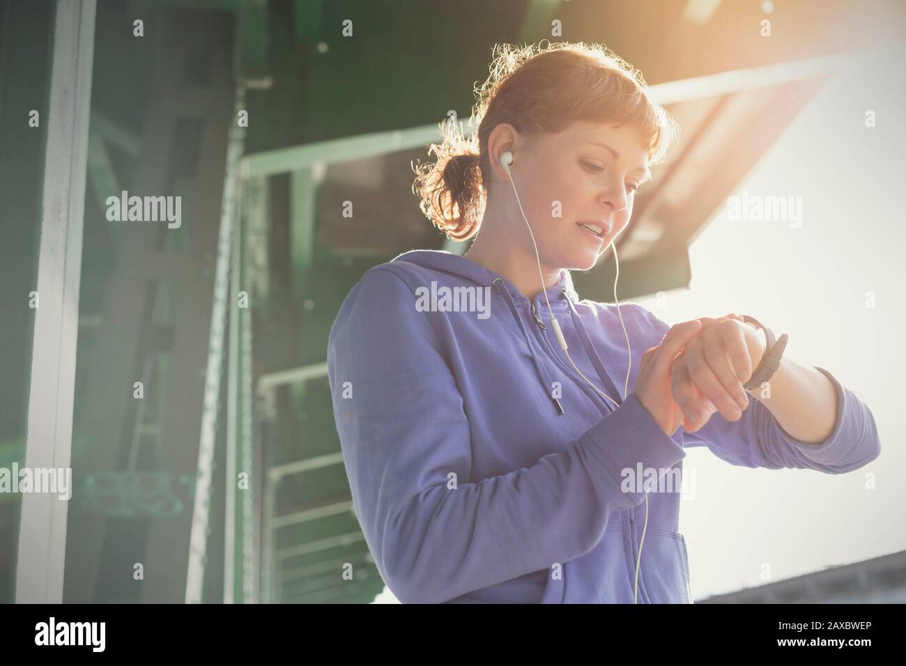 Young female runner checking smart watch Stock Photo