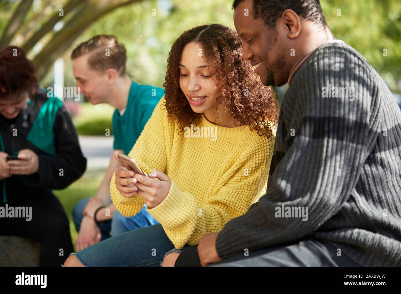 College student friends using smart phone Stock Photo