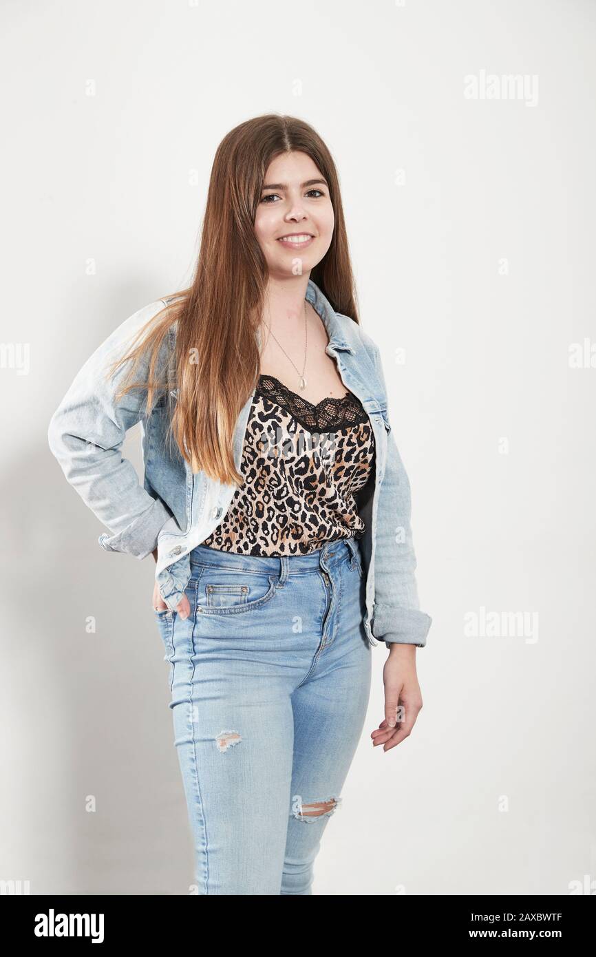 Portrait confident young woman wearing denim jacket and jeans Stock Photo