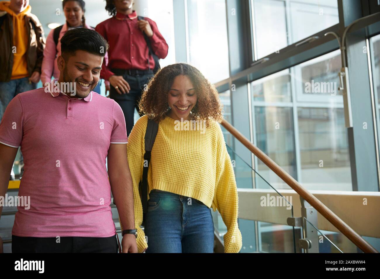 Smiling college students descending staircase Stock Photo
