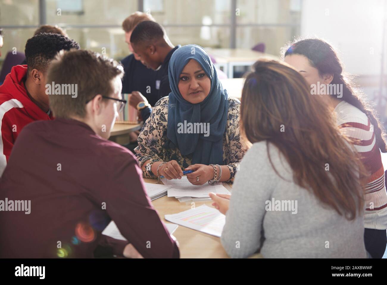 College students talking and studying in classroom Stock Photo