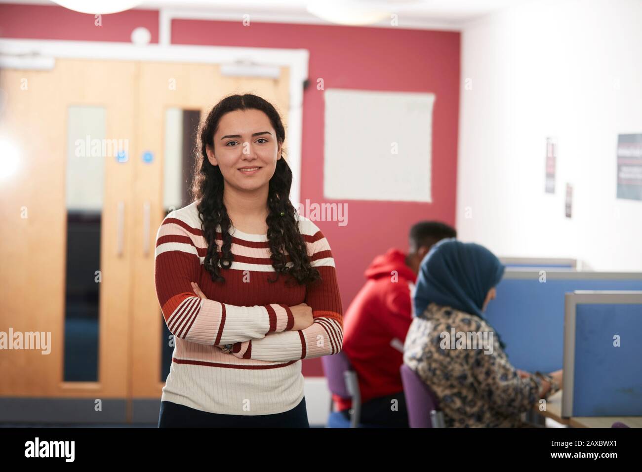 Portrait confident young female college student in library Stock Photo