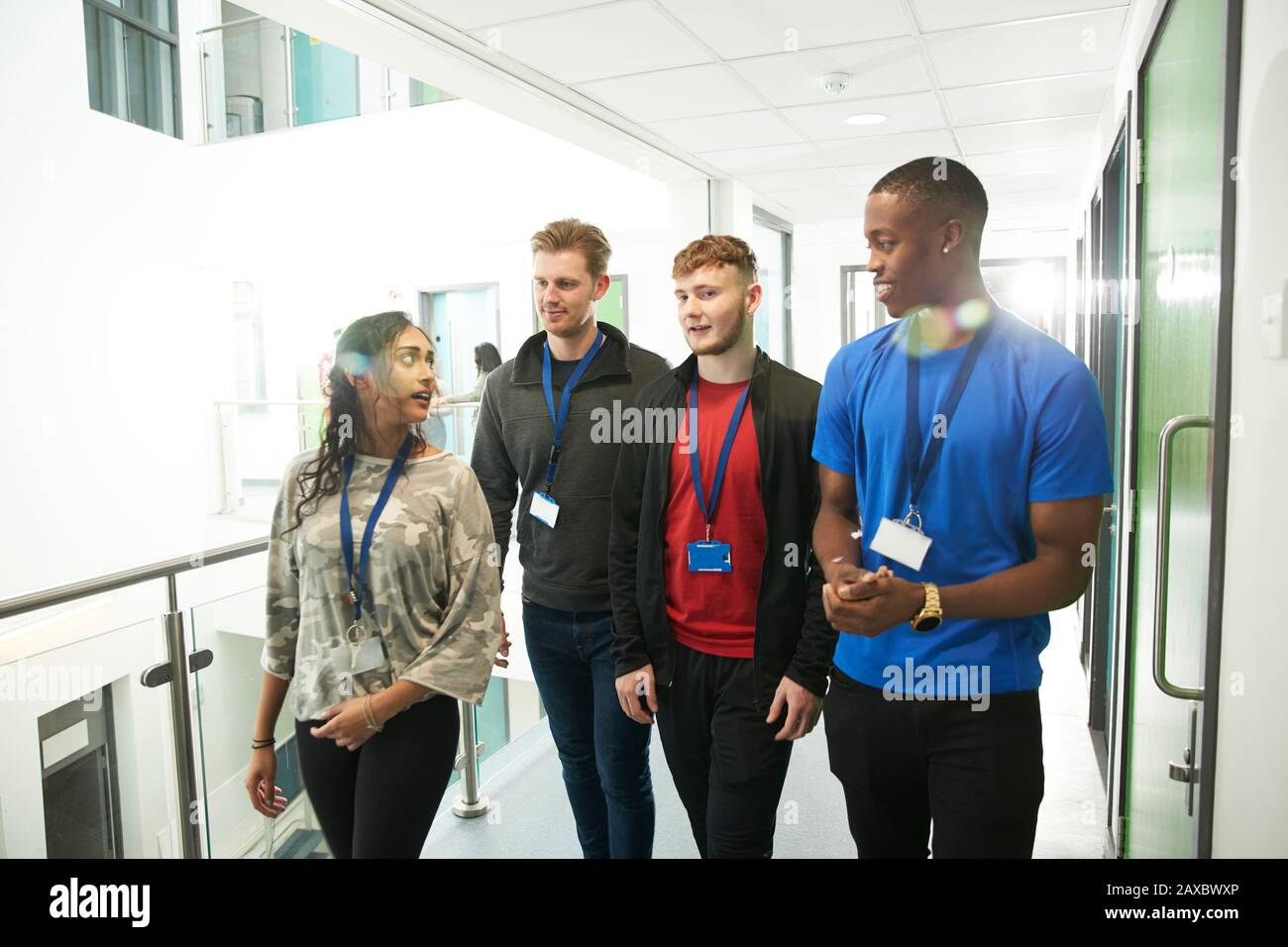 College students talking and walking in corridor Stock Photo - Alamy