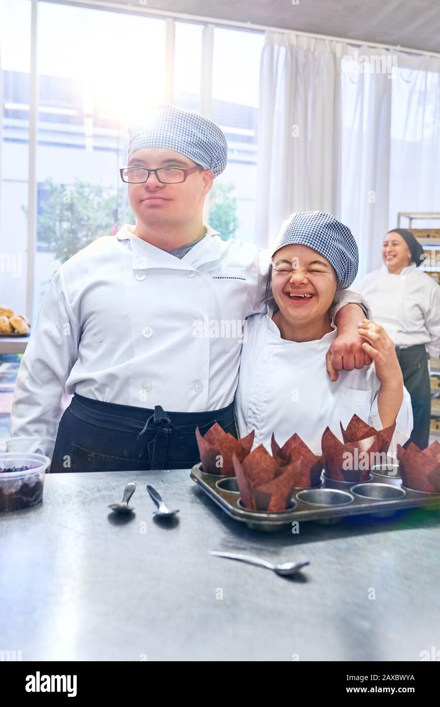 Happy young friends with Down Syndrome in sunny cafe Stock Photo