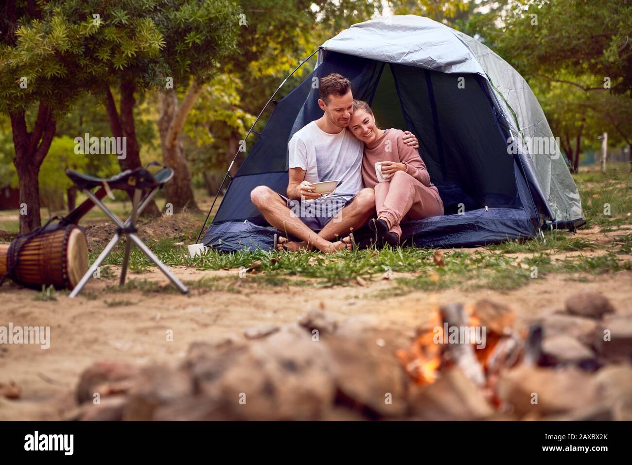 Happy affectionate couple relaxing in tent at campsite Stock Photo Alamy
