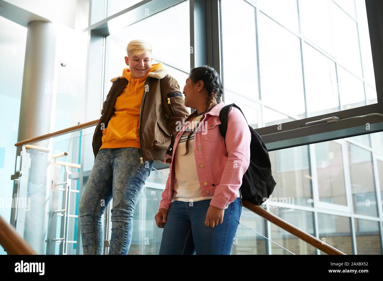 Young female college students talking on staircase Stock Photo