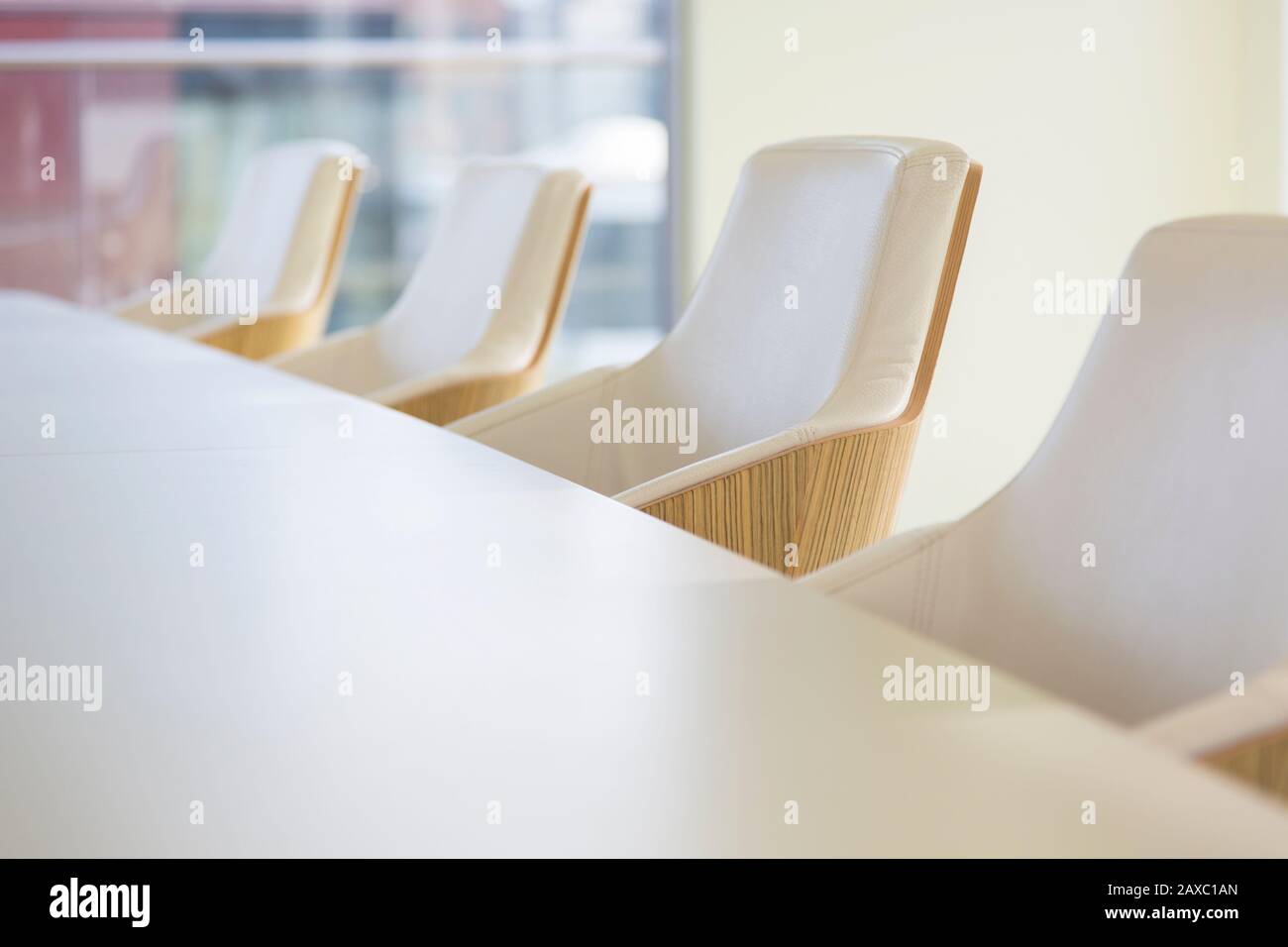 White leather armchairs in a row in conference room Stock Photo
