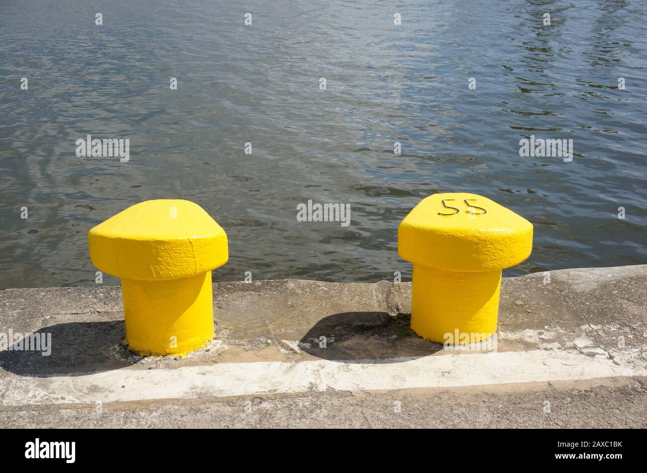 Download A Wide Angle Shot Of Two Yellow Metal Objects In Front Of The Water Stock Photo Alamy PSD Mockup Templates