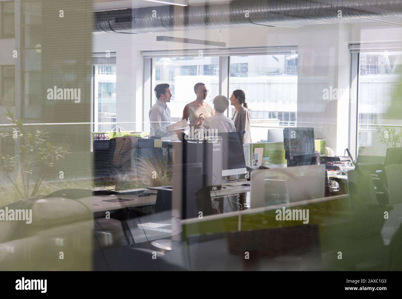 Business people talking, meeting in open plan office Stock Photo