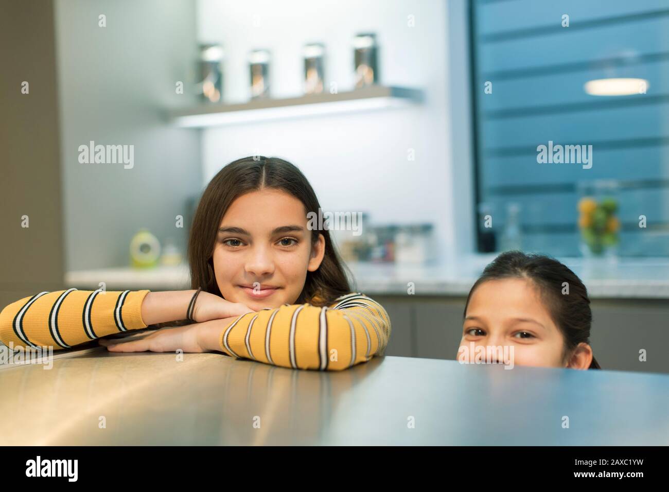 Portrait smiling sisters in kitchen Stock Photo - Alamy