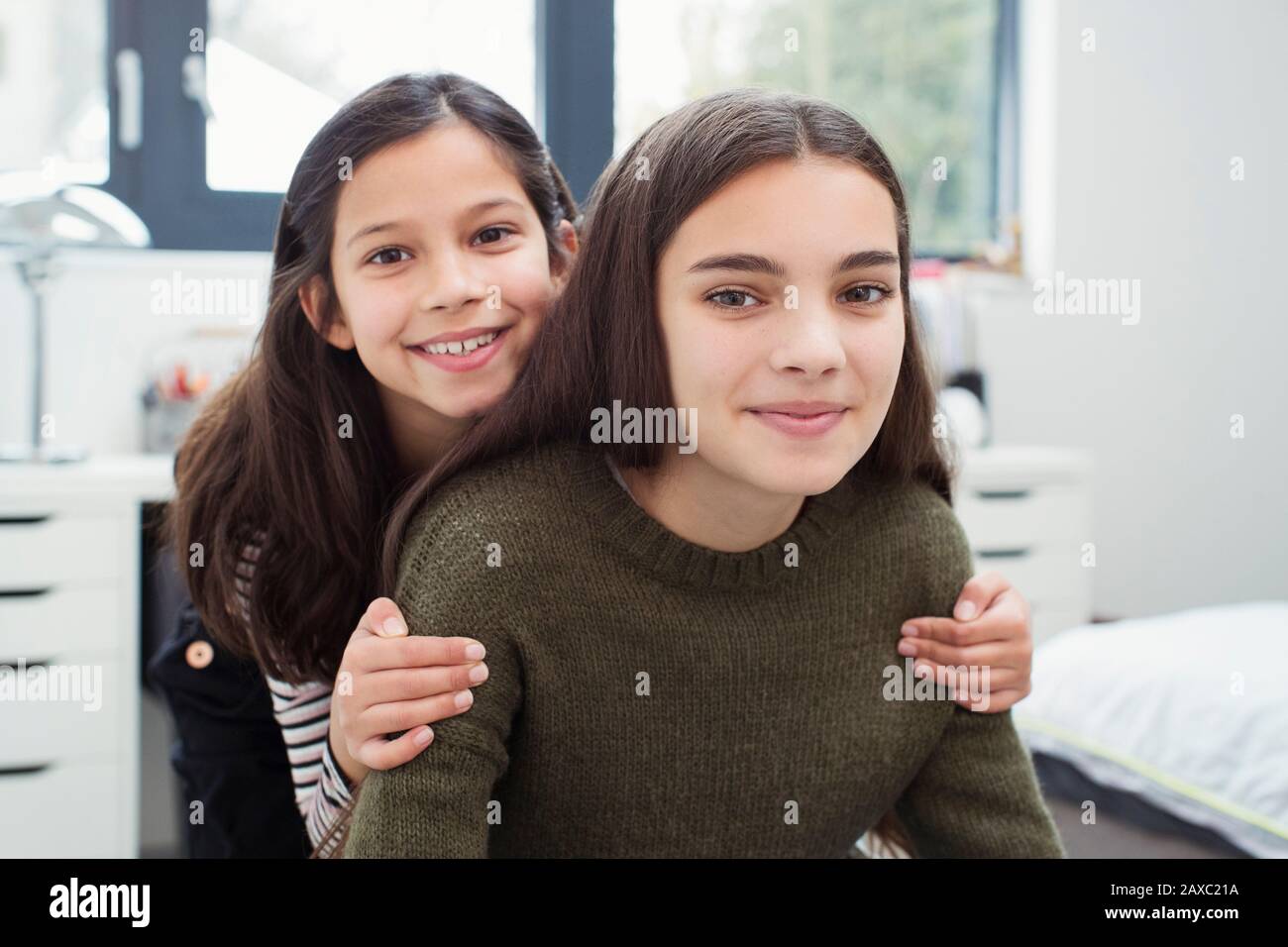 Portrait happy, affectionate sisters at home Stock Photo