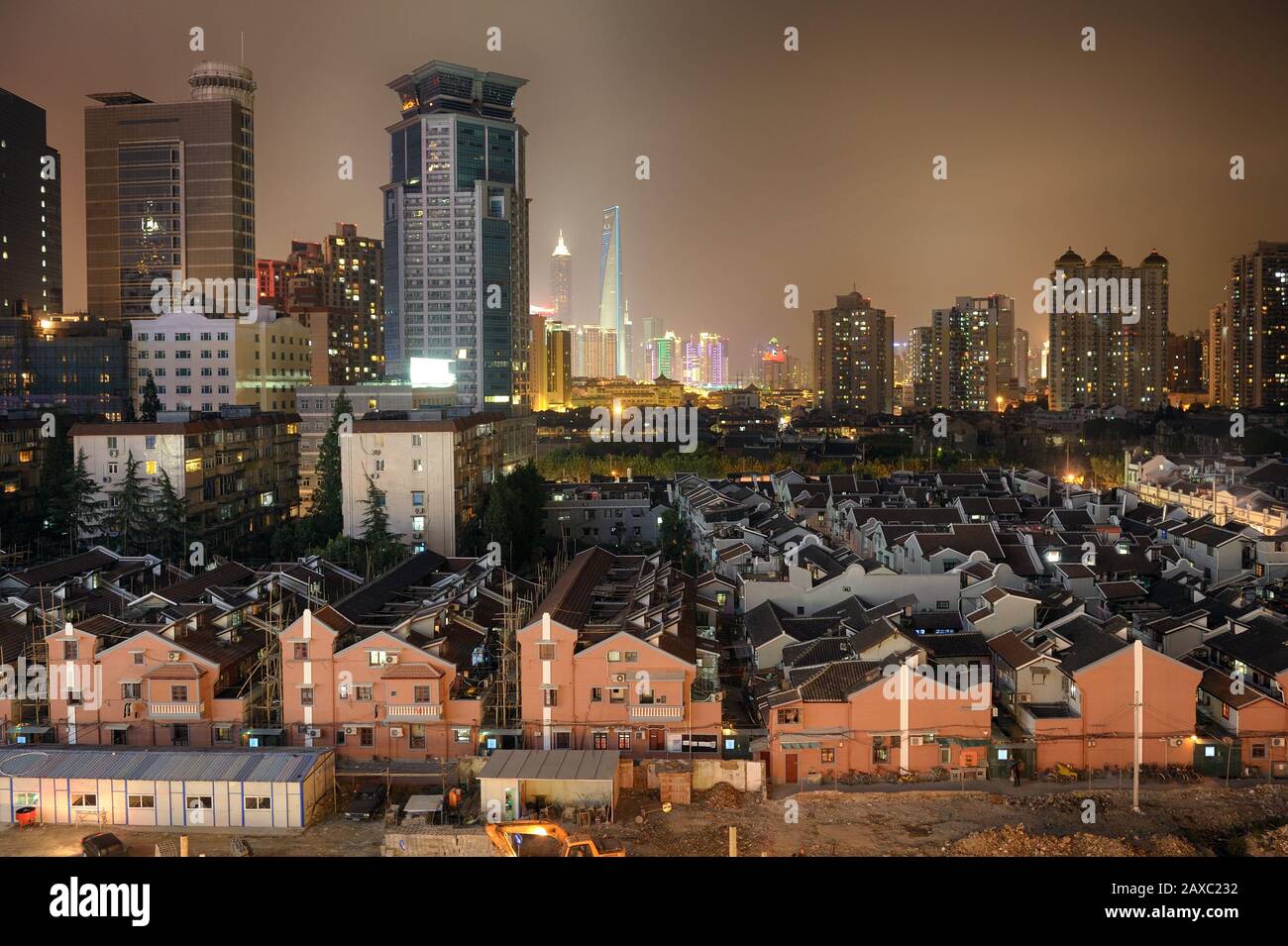 Old Shanghai area in foreground, new Pudong financial district in background. Jin Mao and SWFC are visible. Stock Photo