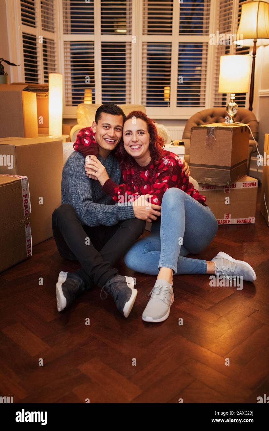 Portrait happy, affectionate couple moving house Stock Photo