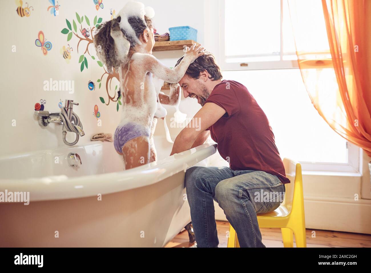 Playful father giving daughter bubble bath Stock Photo Alamy