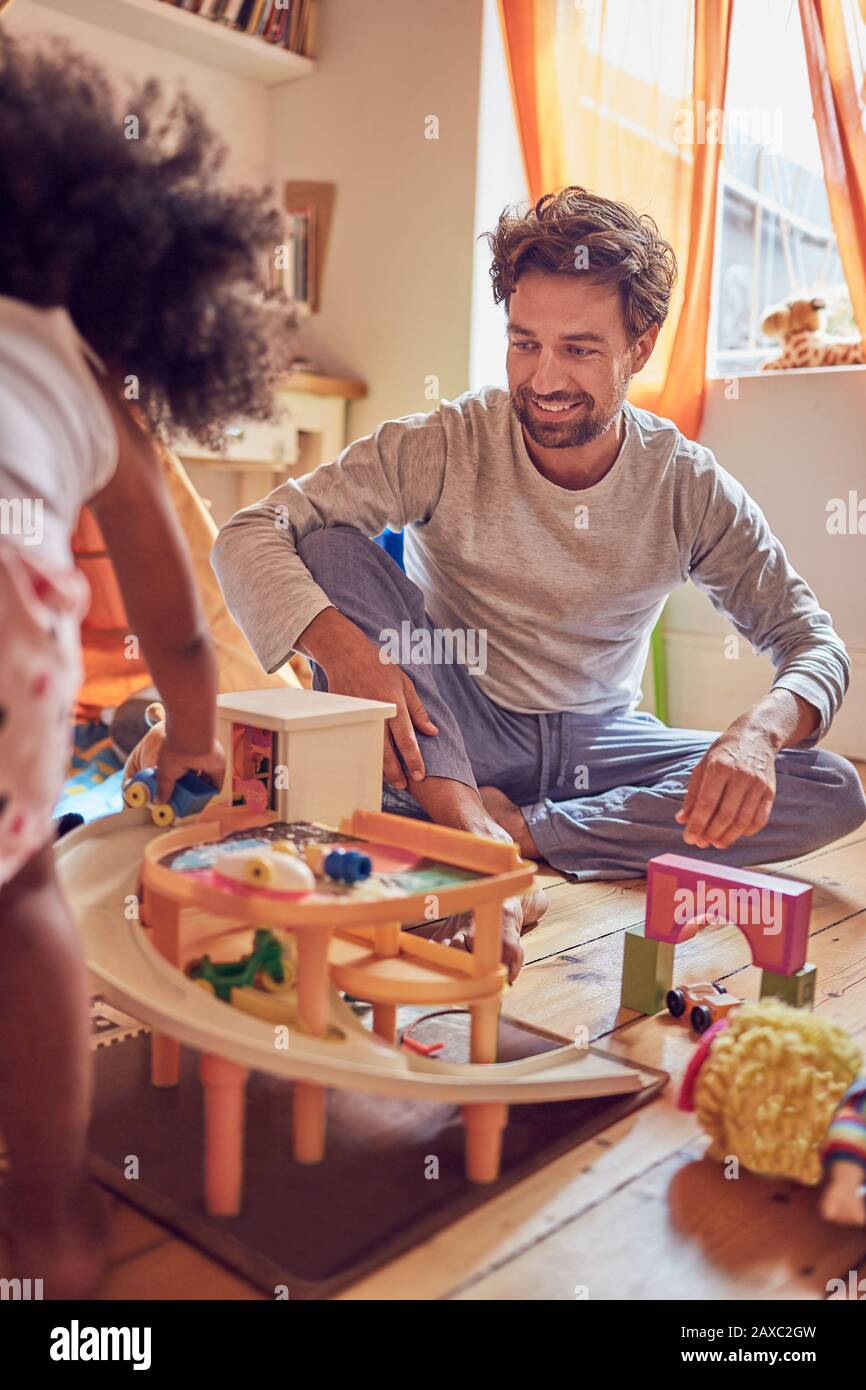 Father and daughter playing with toys Stock Photo