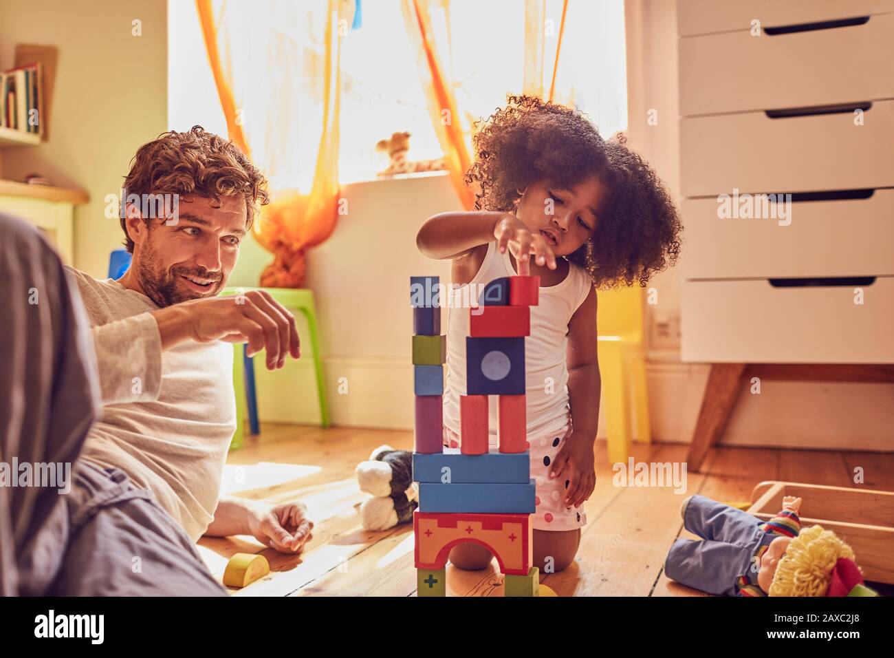 Father and daughter playing with wood blocks Stock Photo