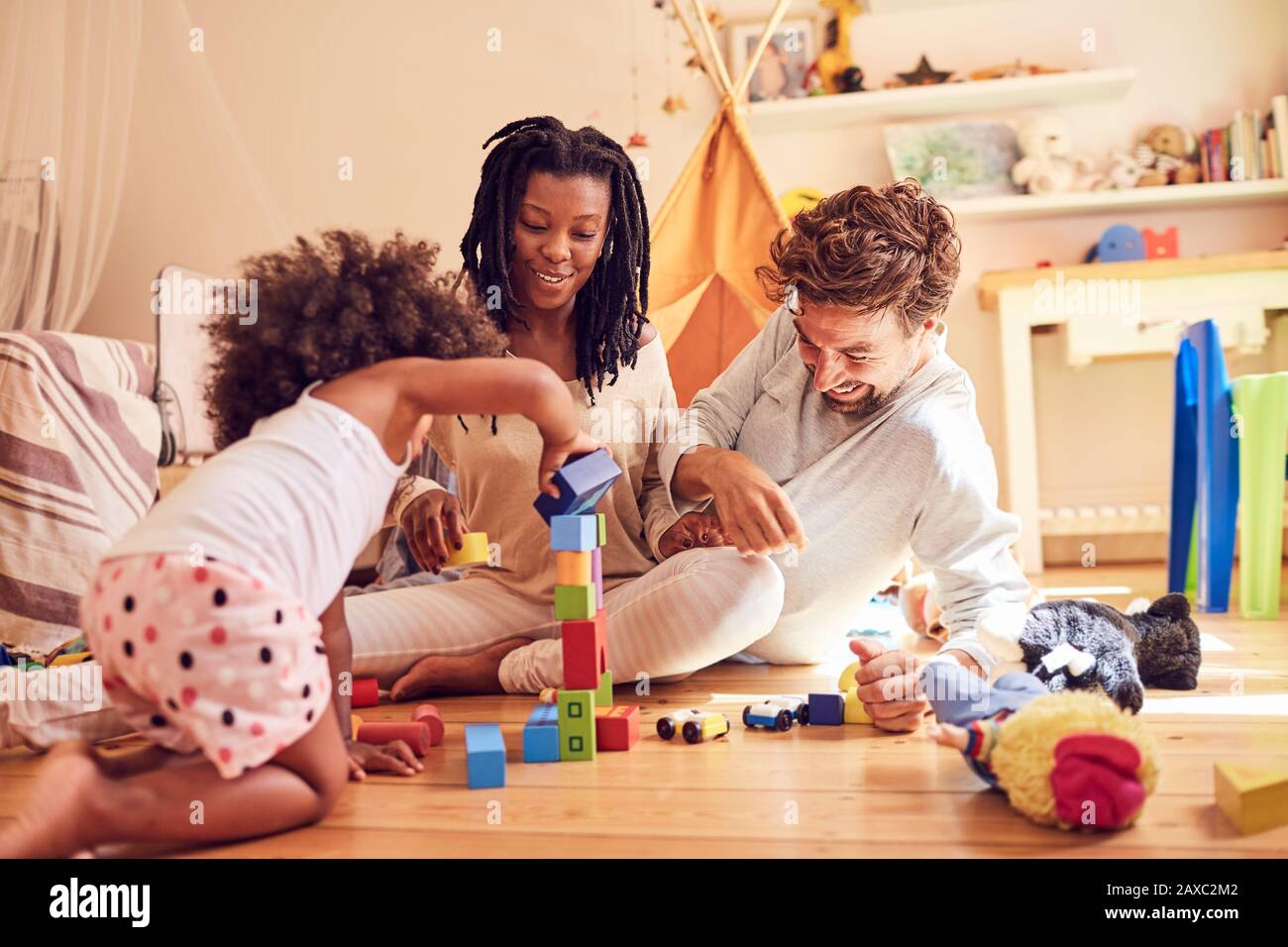 Young family playing with wood blocks Stock Photo