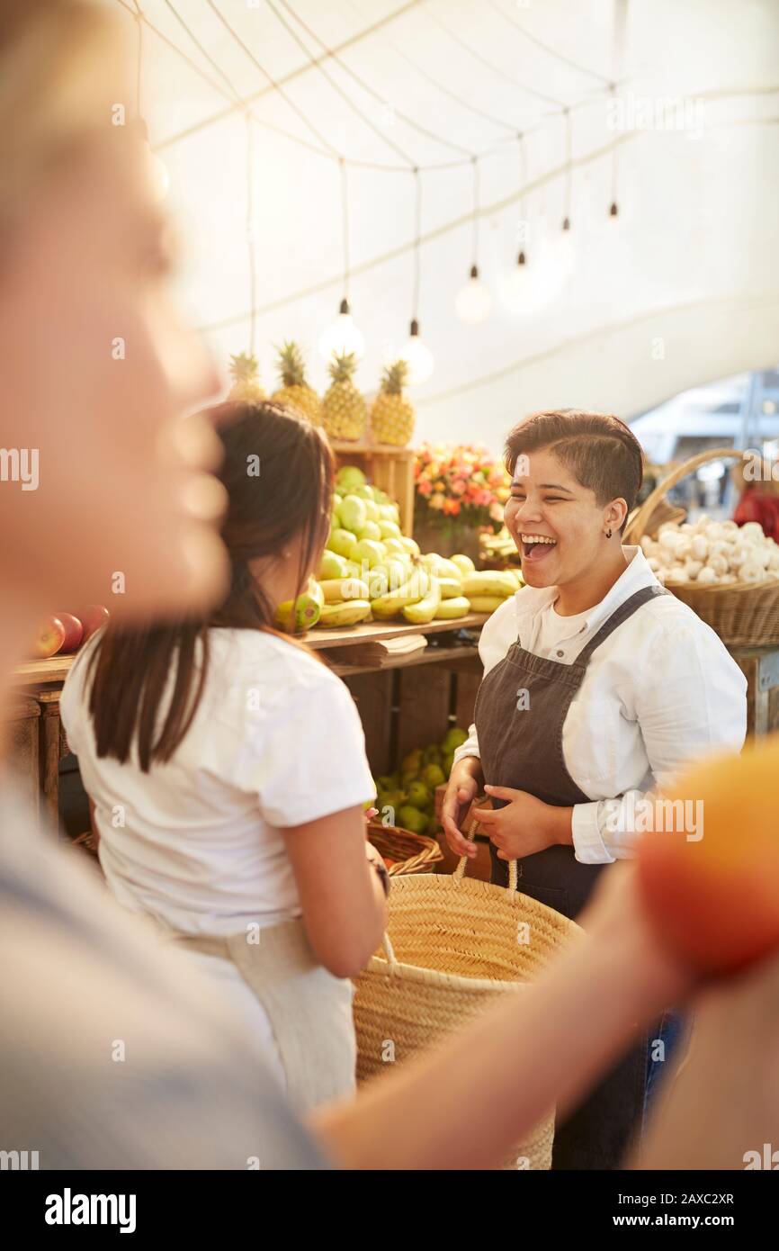 Laughing woman working at farmer’s market Stock Photo