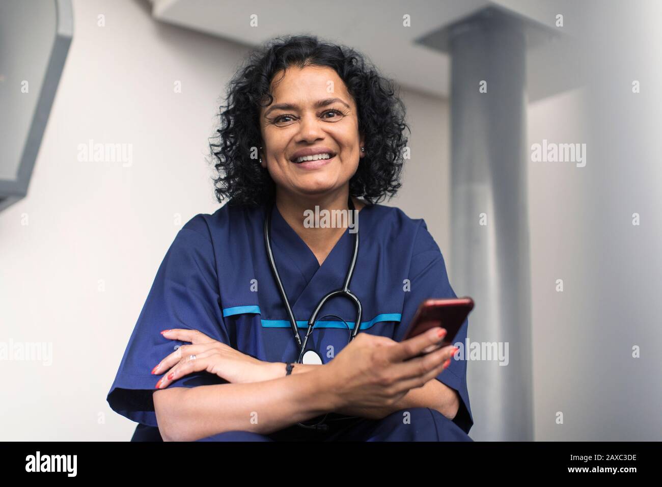 Portrait confident female doctor using smart phone Stock Photo