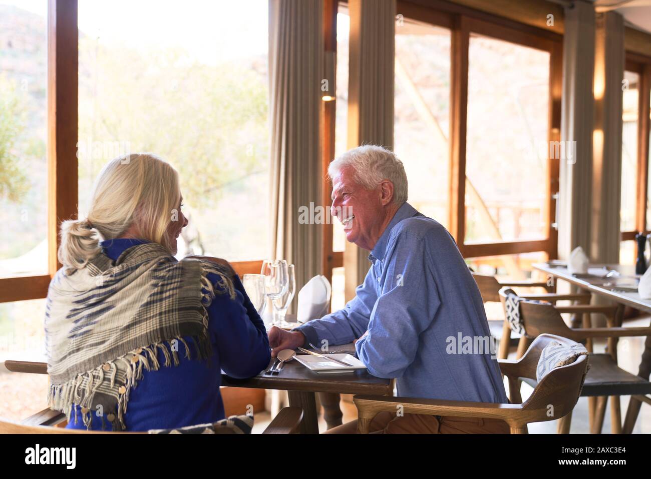 Happy senior couple dining in restaurant Stock Photo