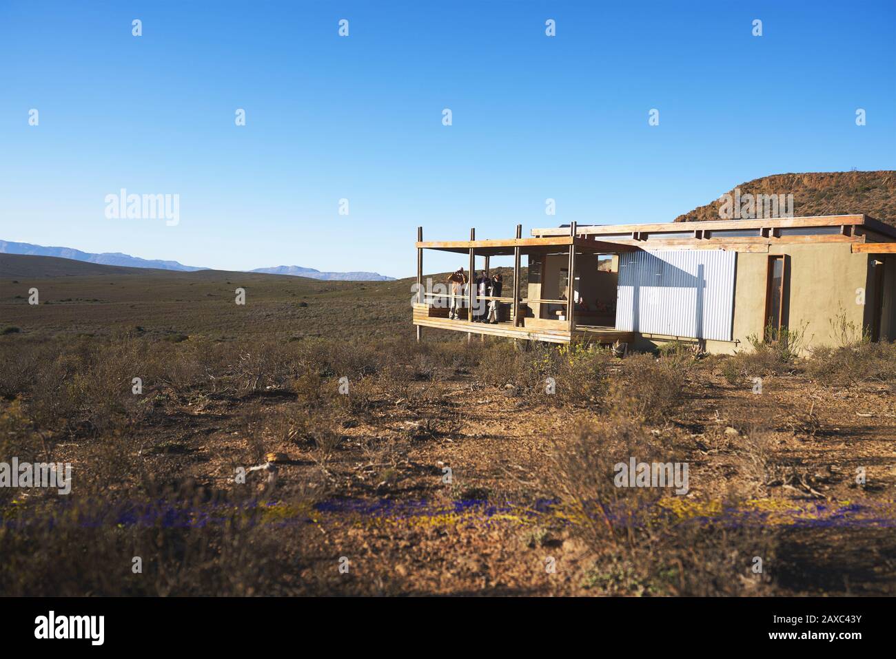 Friends on sunny balcony of safari cabin South Africa Stock Photo