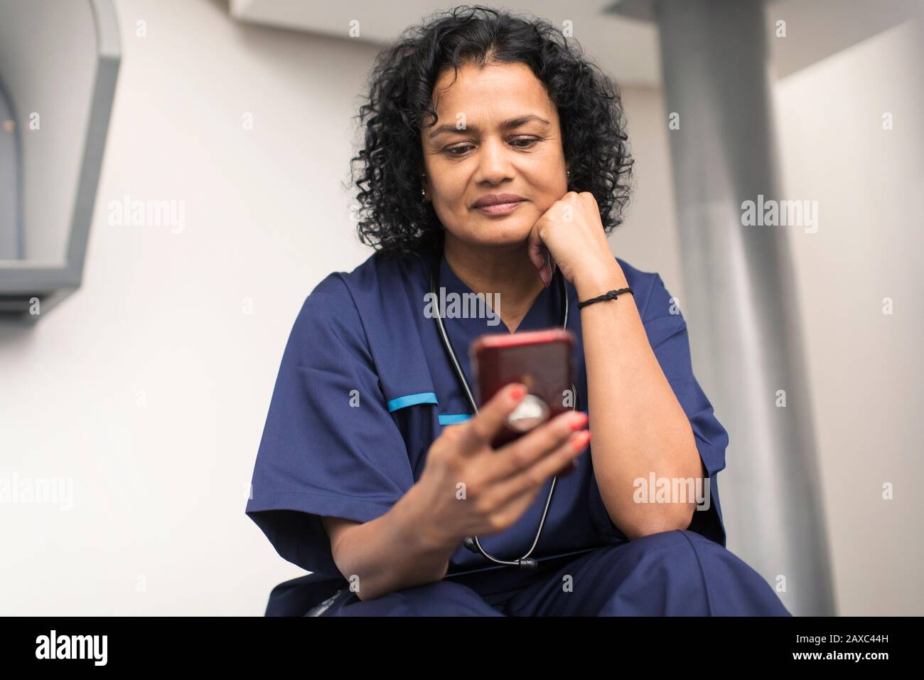 Female doctor using smart phone Stock Photo