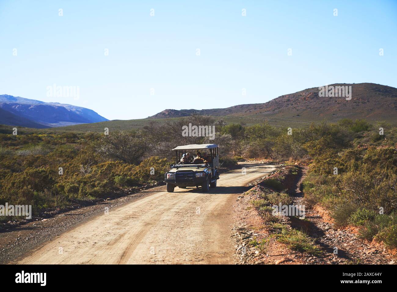 Safari off-road vehicle on sunny emote dirt road South Africa Stock Photo
