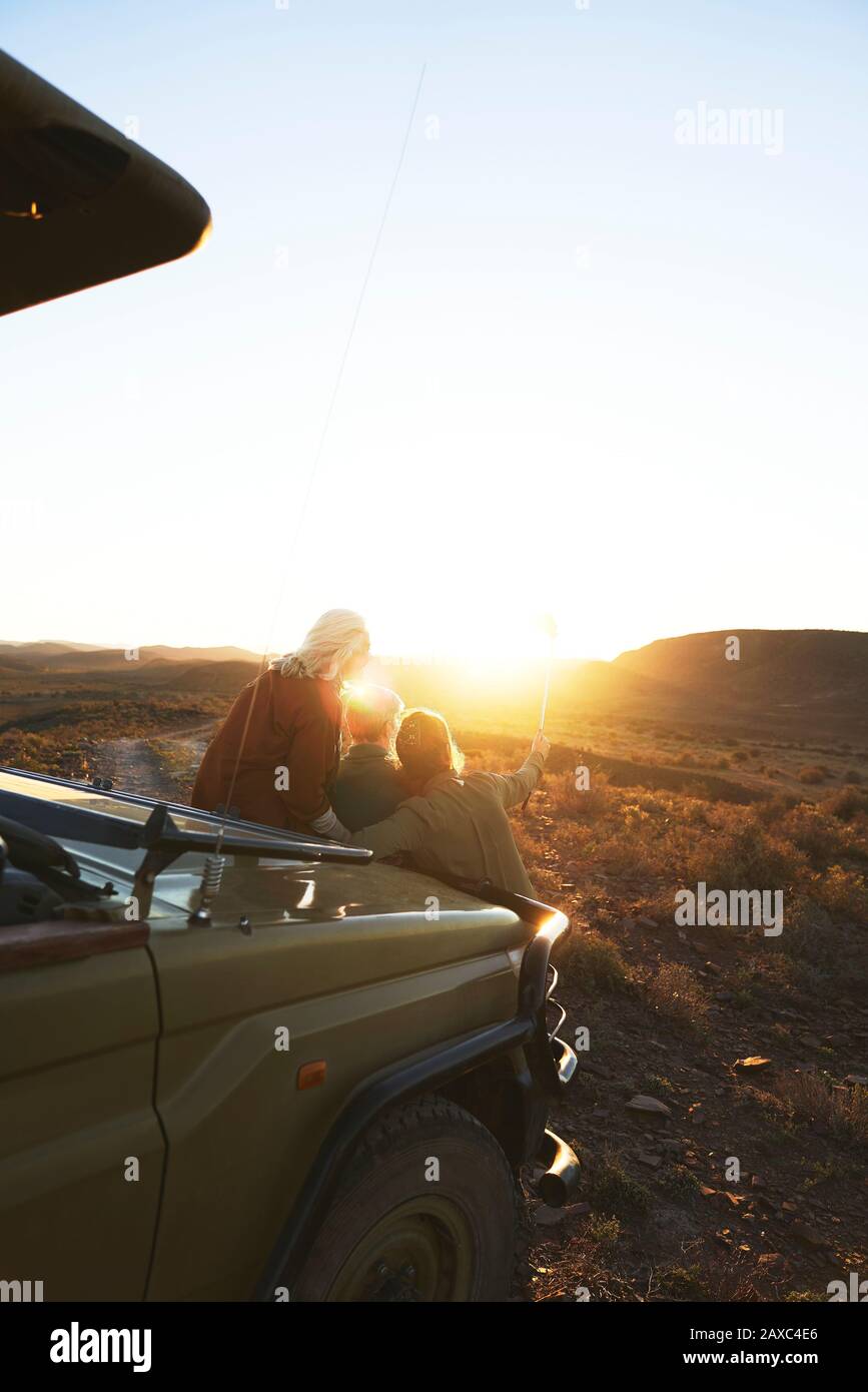 Friends on safari enjoying scenic sunrise South Africa Stock Photo