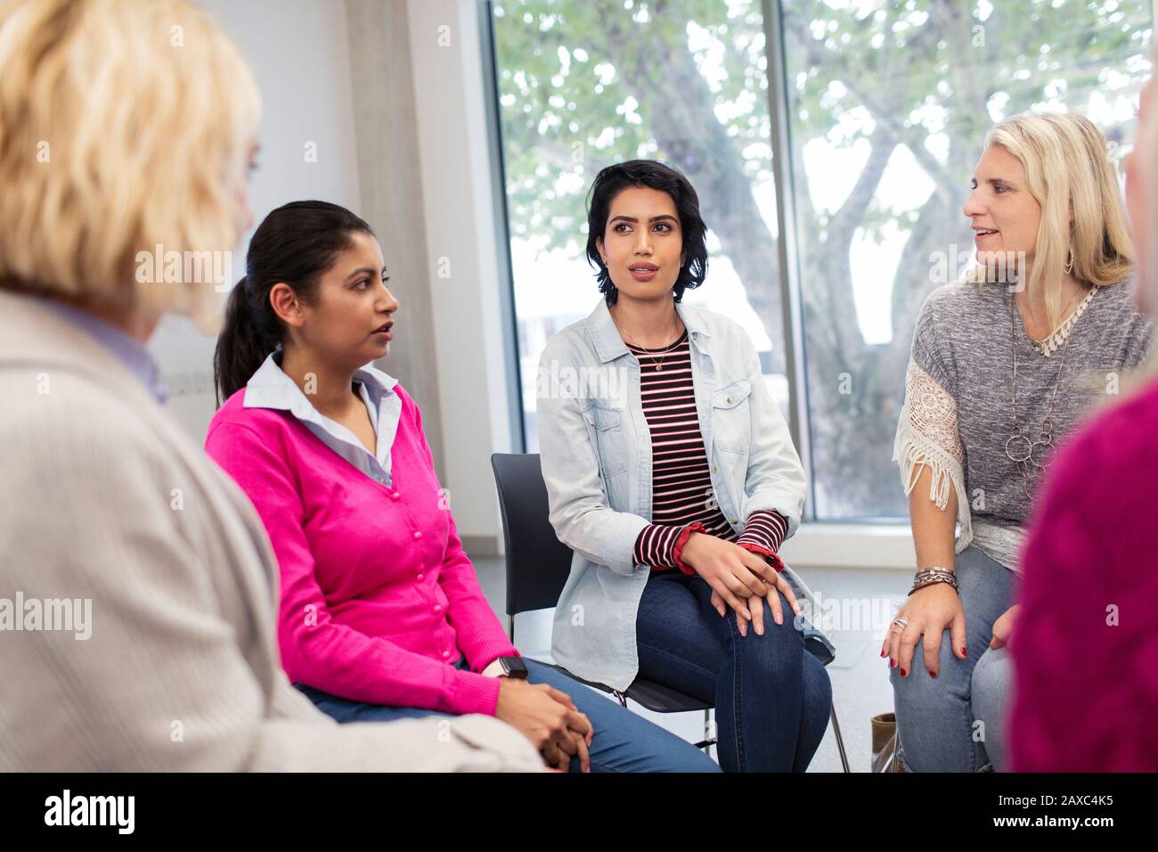 Women's support group talking in circle Stock Photo
