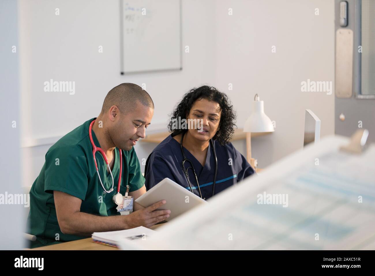 Doctors using digital tablet in clinic Stock Photo