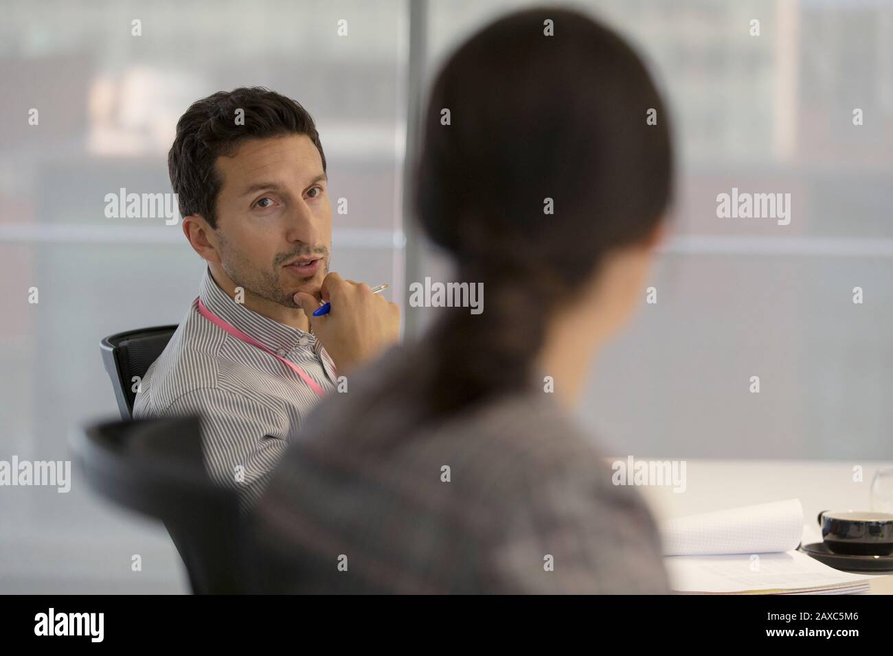 Attentive businessman listening to colleague in meeting Stock Photo