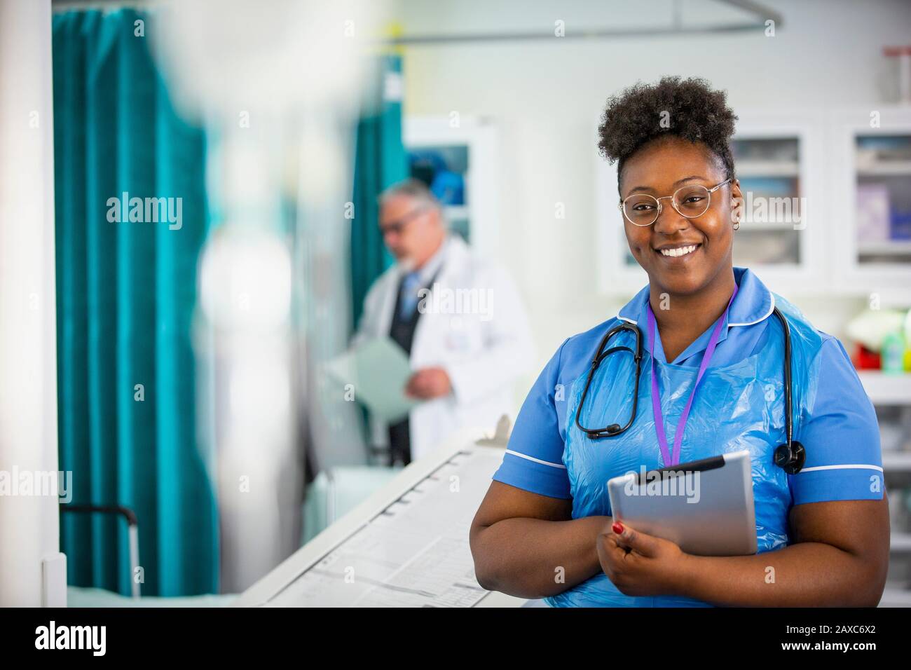 Portrait confident female nurse with digital tablet in hospital Stock Photo