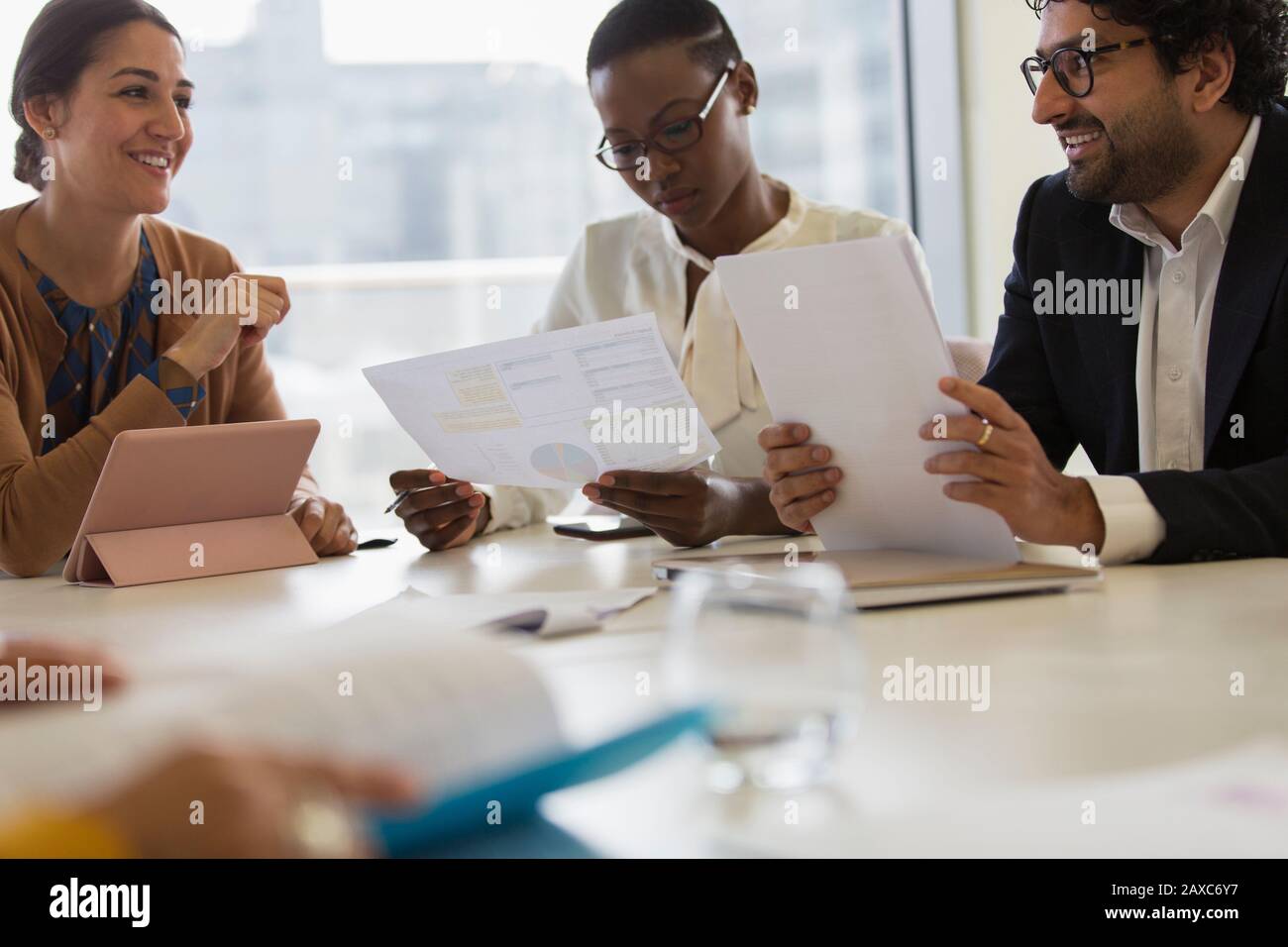 Business people discussing paperwork in conference room meeting Stock ...