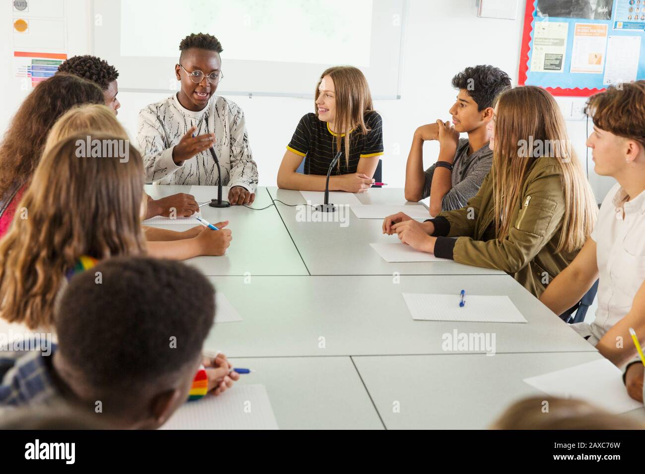 High school students talking at table in debate class Stock Photo