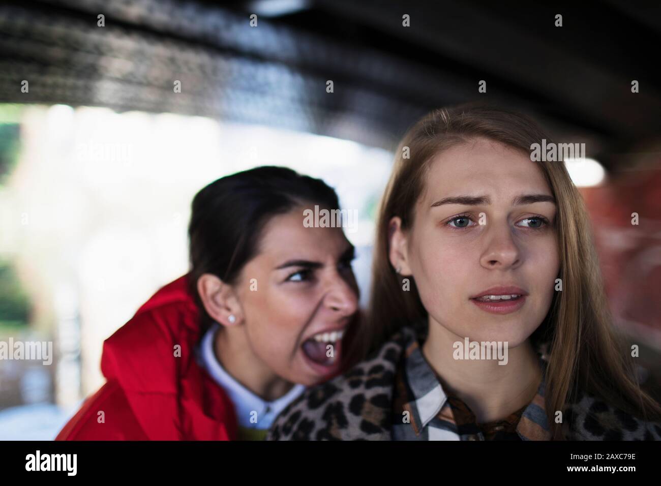 Angry young woman yelling at friend Stock Photo
