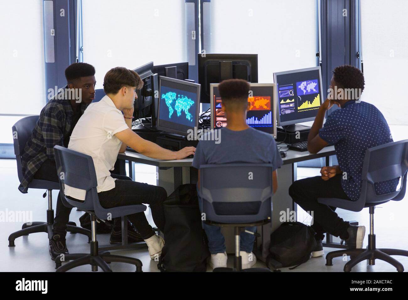 Junior high boy students using computers in computer lab Stock Photo