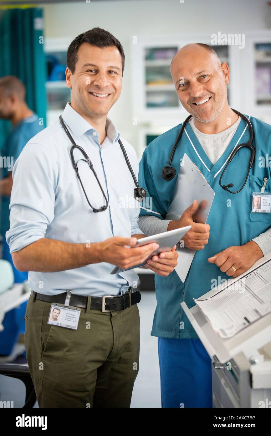 Portrait confident male doctors using digital tablet in hospital Stock Photo
