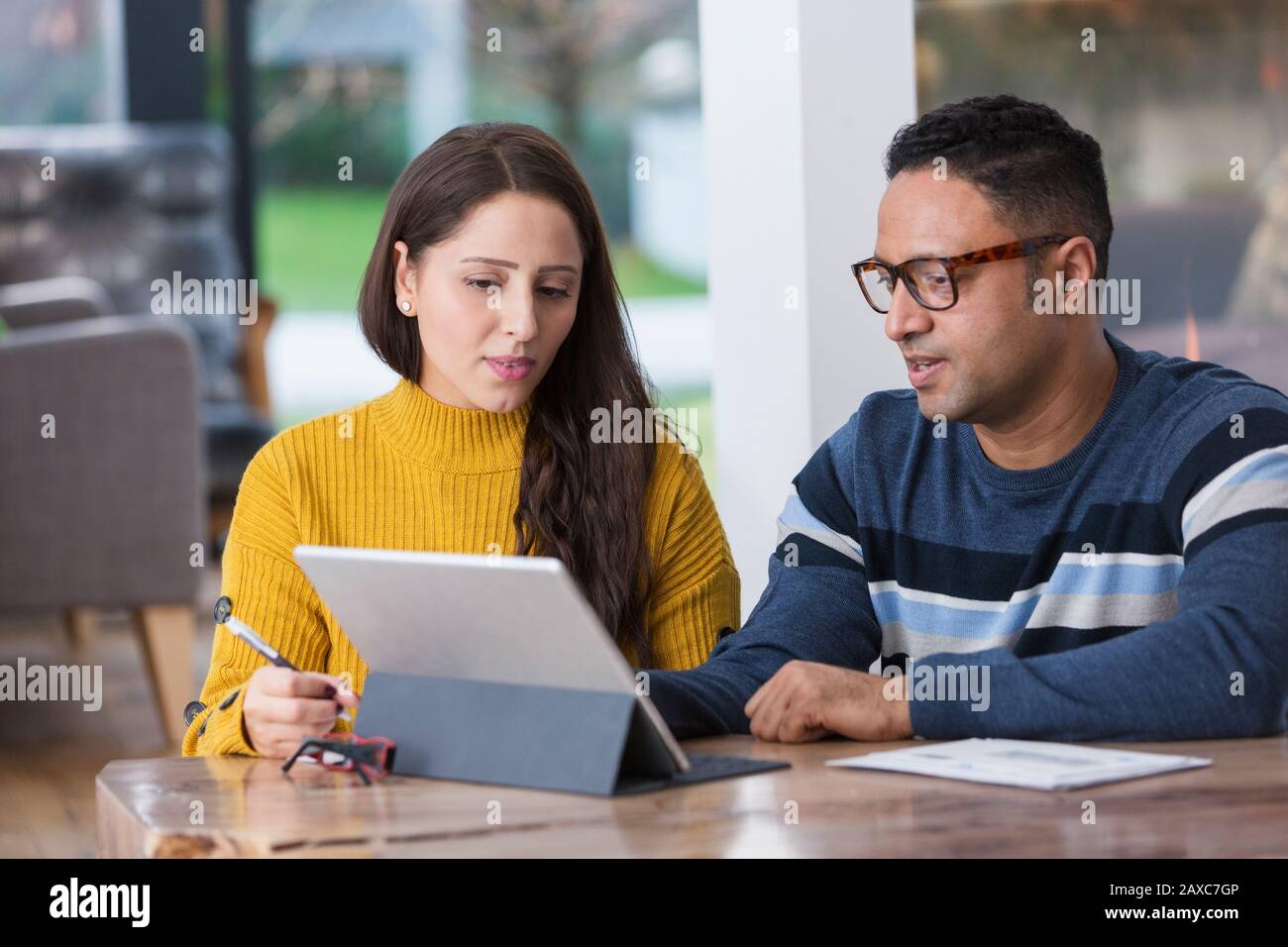 Couple paying bills at digital tablet Stock Photo