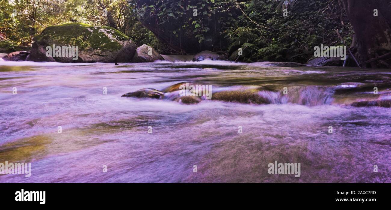 River Surrounded By Rocks Wide angle shot of a river surrounded by rocks and stones Stock Photo ...