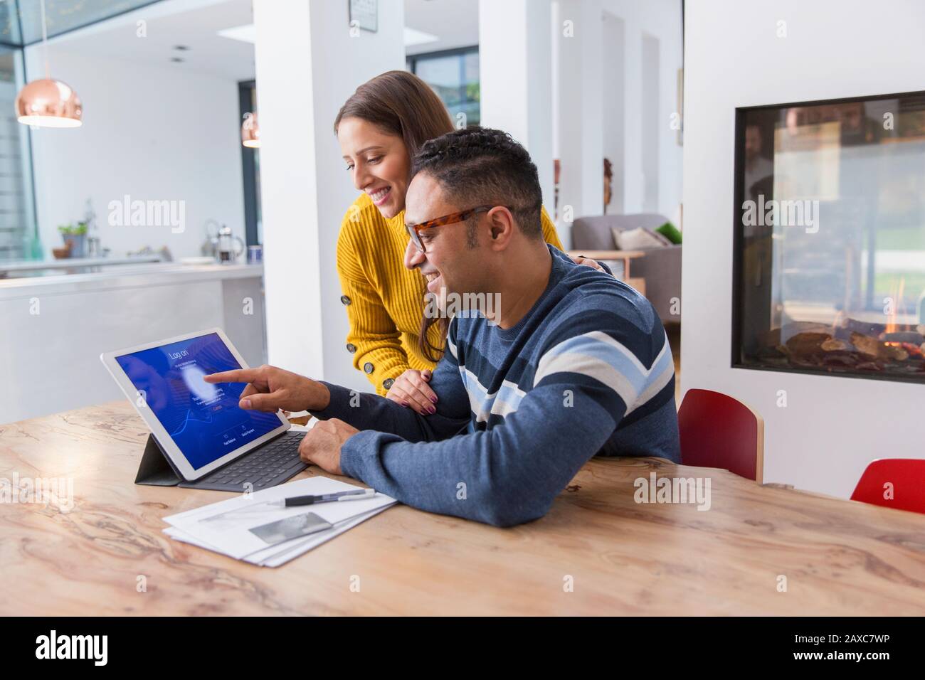 Couple paying bills at digital tablet Stock Photo