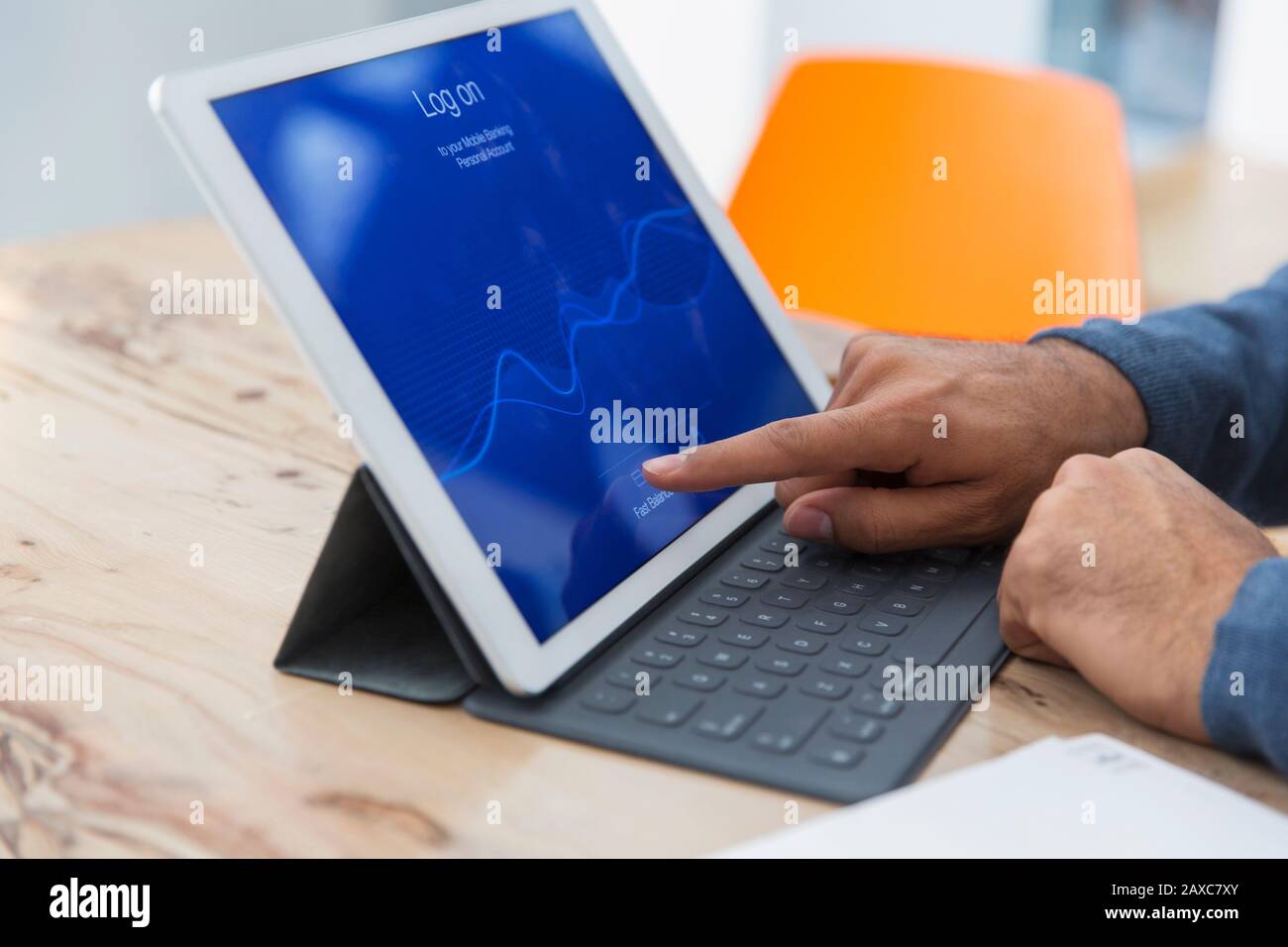 Close up man using digital tablet, logging on Stock Photo