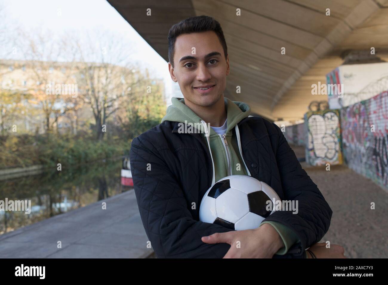 Portrait confident young man with soccer ball Stock Photo