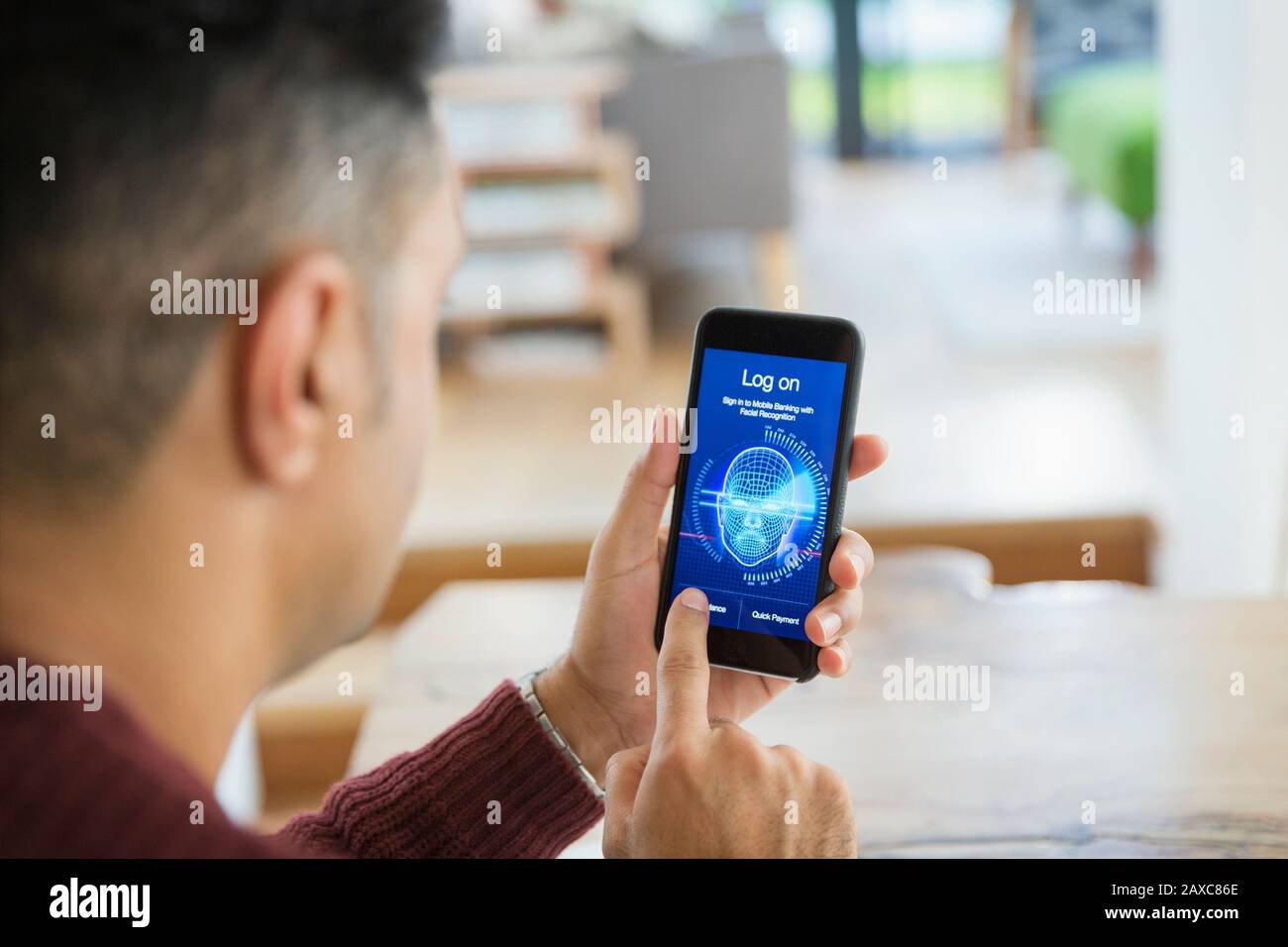 Man logging on to smart phone with facial recognition Stock Photo